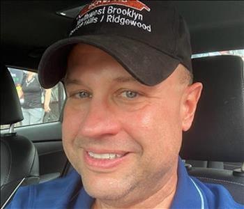 male portrait, black servpro hat