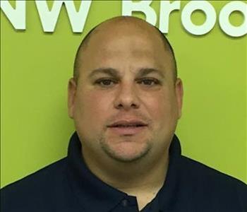 shaved head, black shirt male portrait